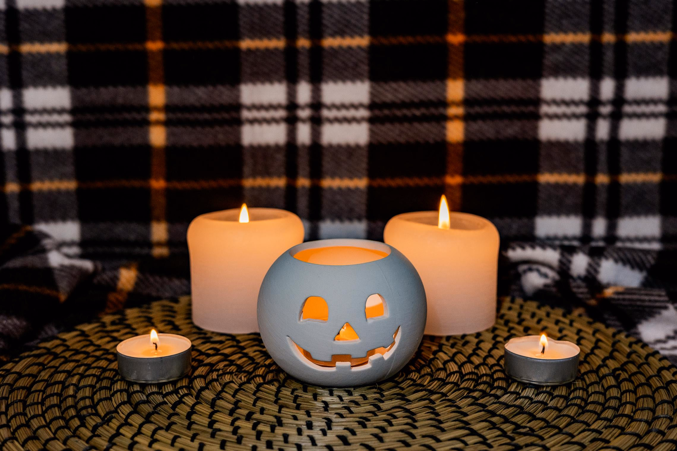 Affordable Halloween party setup with thrift store candelabras, DIY paper bats, and grocery store pumpkins
