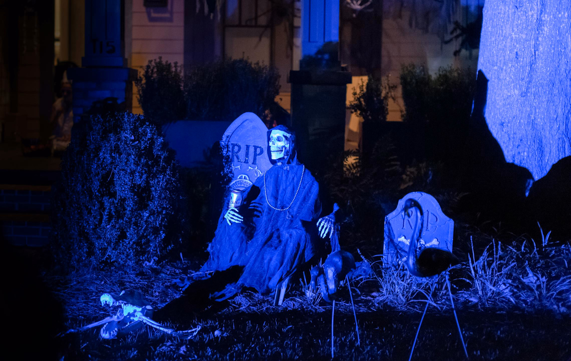 Walkthrough yard haunt at night with fog, purple lighting, and silhouetted figures along a path