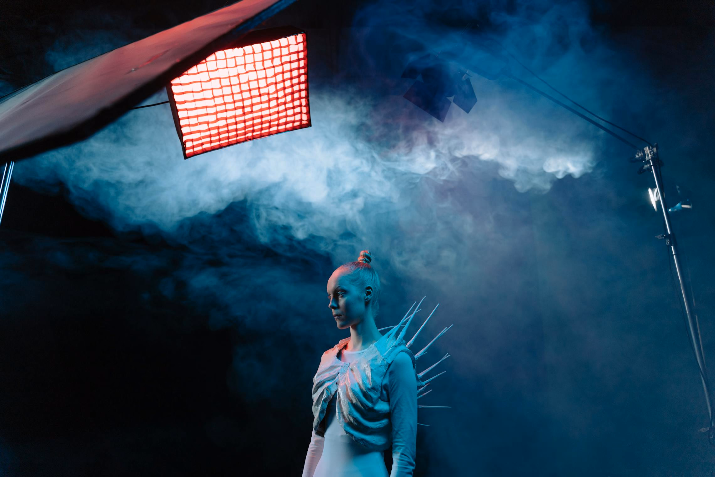 Several fog machines of different sizes lined up on a workbench in a dimly lit garage