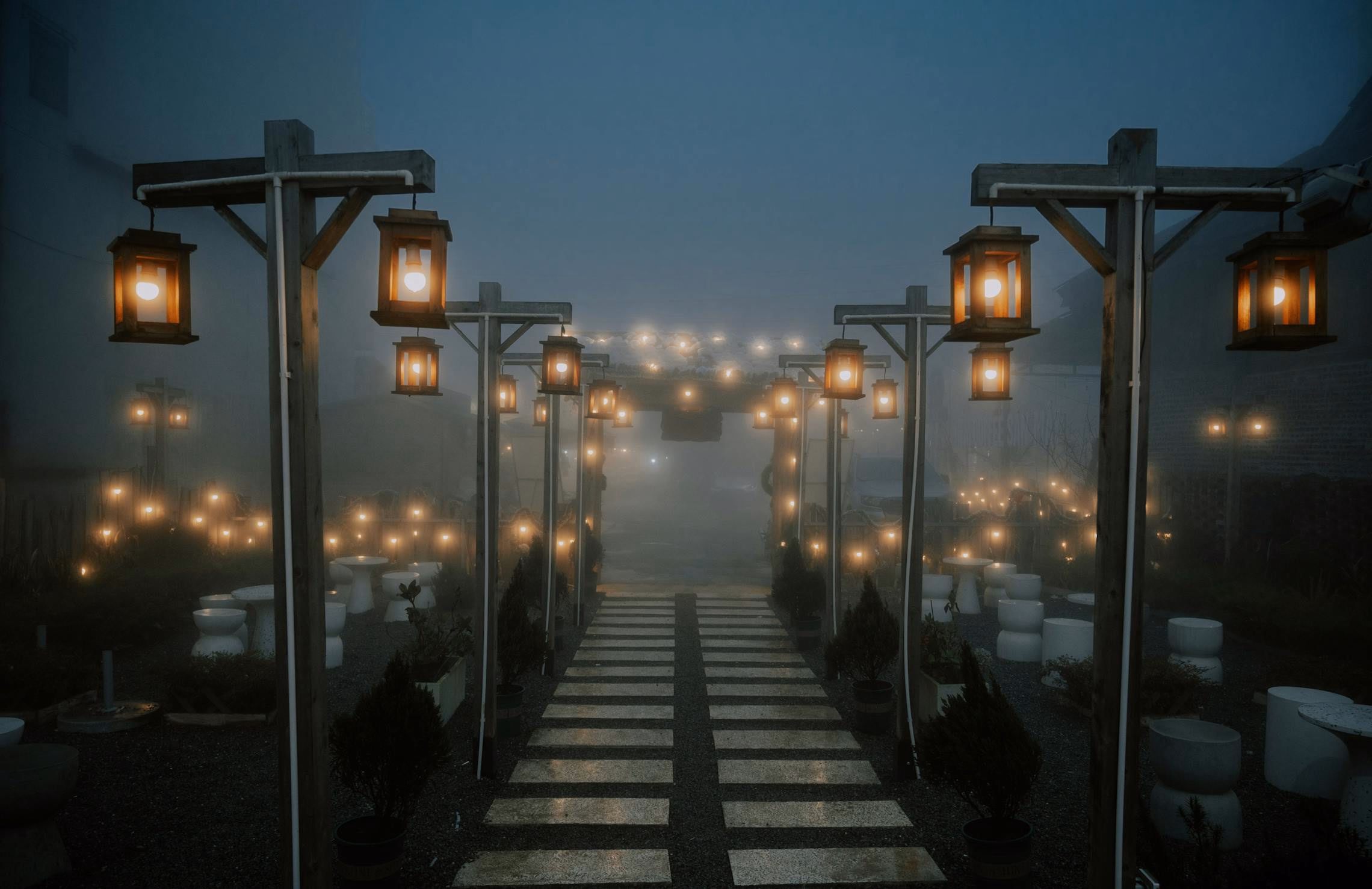 Thick fog rolling across a front yard graveyard scene with uplighting illuminating the mist
