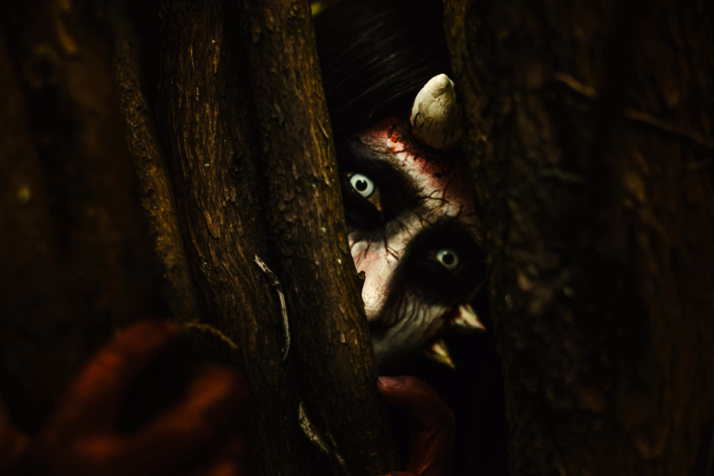 A long dark corridor with a single dim light at the far end casting a faint glow on the walls