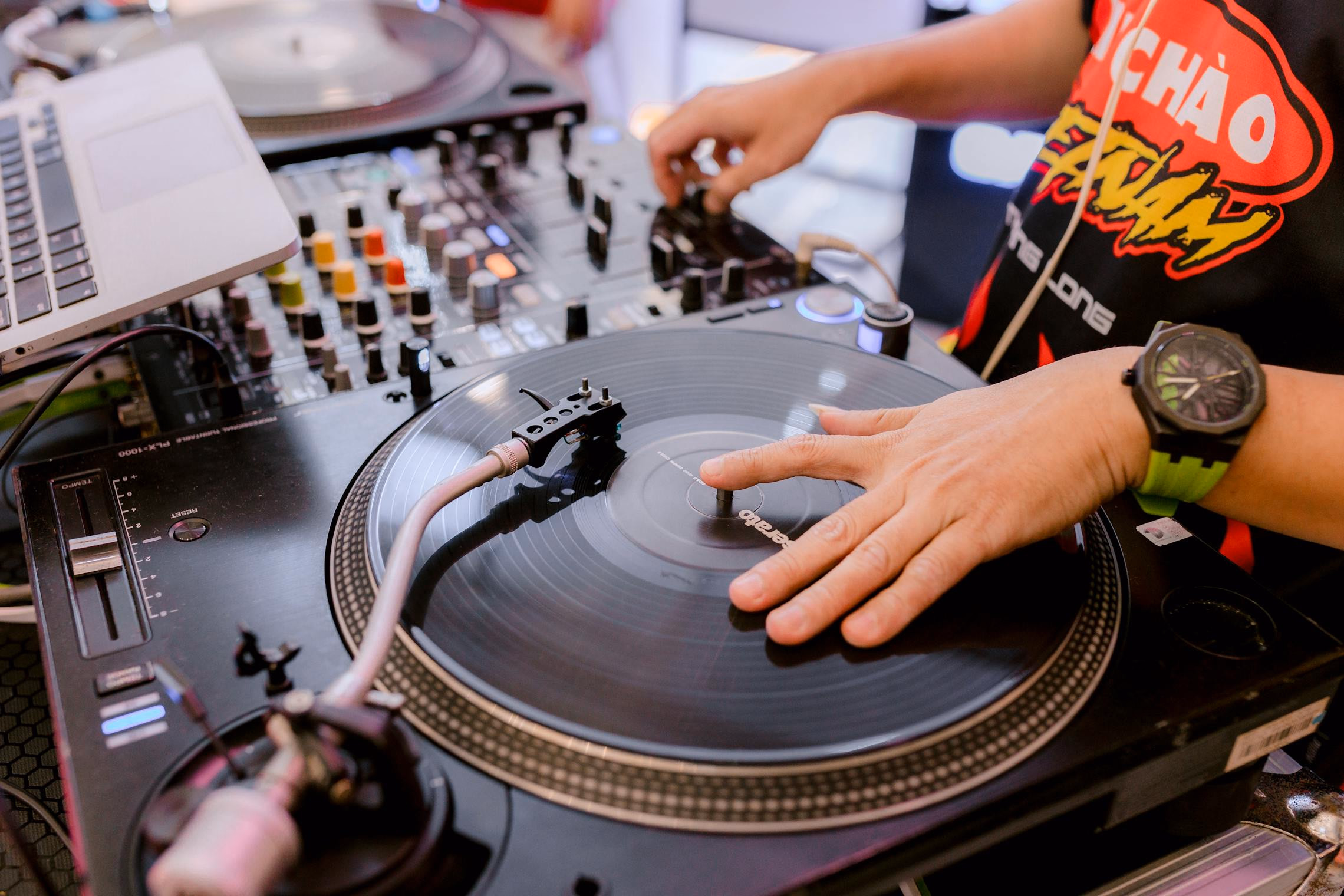 Turntable and headphones bathed in purple and orange Halloween lighting